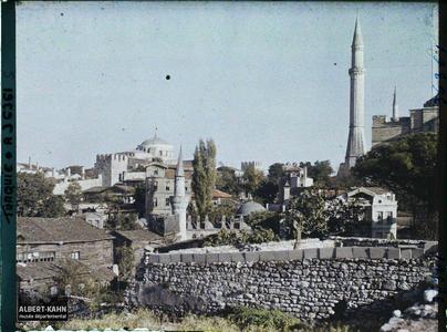 Turquie, Constantinople, Minaret N-O. de Ste-Sophie et mosquée Rouge. Quartier de Aya Sofya Camii («mosquée Sainte-Sophie») avec au centre, derrière un mur et des maisons, la Cafer Aga (ou Caferaga) Medresesi, à gauche, la coupole de Aya Irini Kilisesi («église Sainte-Irène») et à droite, un minaret ouest de Aya Sofya Camii («mosquée Sainte-Sophie»)